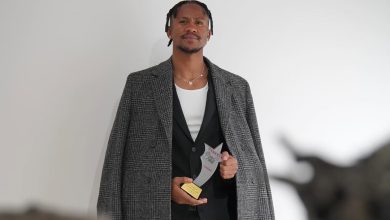 Siyabonga Ngezana holding one of his two awards.