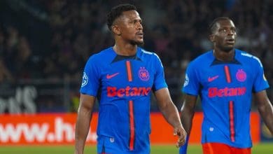 FCSB defender Siyabonga Ngezana and teammate walking in the pitch