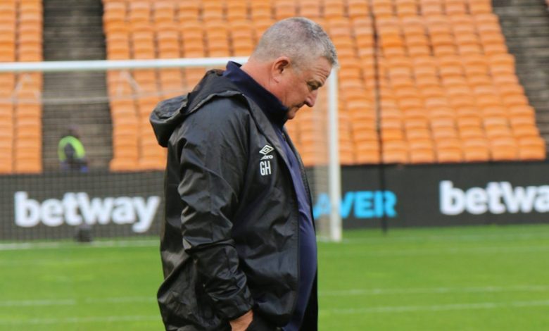 Coach Gavin Hunt walking on the pitch before a SuperSport United game