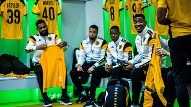 Kaizer Chiefs players in the change before a game having a chat