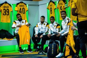 Kaizer Chiefs players in the change before a game having a chat