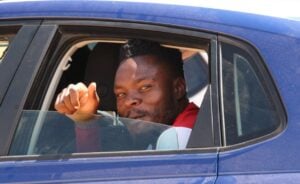 Meshack Maphangule waving inside a car.