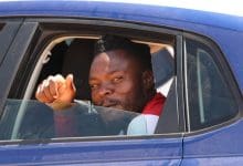 Meshack Maphangule waving inside a car.