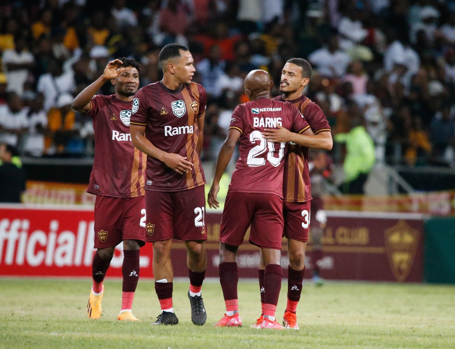 Stellenbosch FC players celebrating a goal scored against Kaizer Chiefs