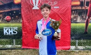 Camden Schaper at Blackburn Rovers with a medal and trophy won