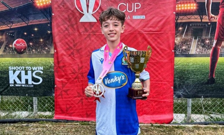 Camden Schaper at Blackburn Rovers with a medal and trophy won