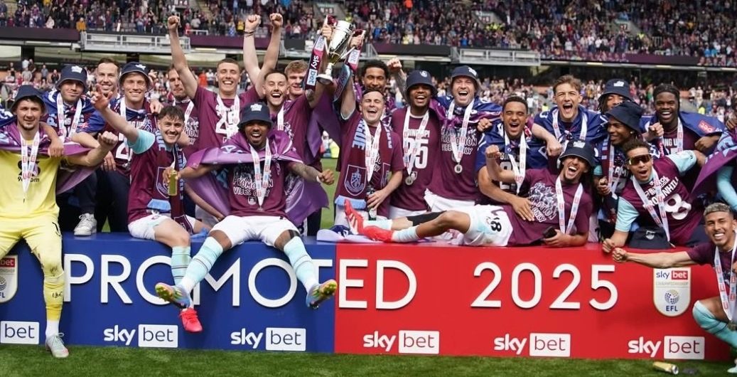 Burnley FC players celebrating after lifting the EFL Championship runner-up title