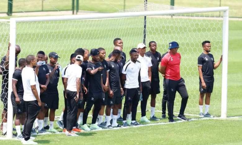 Orbit College players standing at a goal post before a match