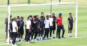 Orbit College players standing at a goal post before a match