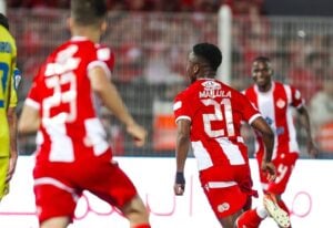 Wydad AC players celebrating a goal including Cassius Mailula and Thembinkosi Lorch