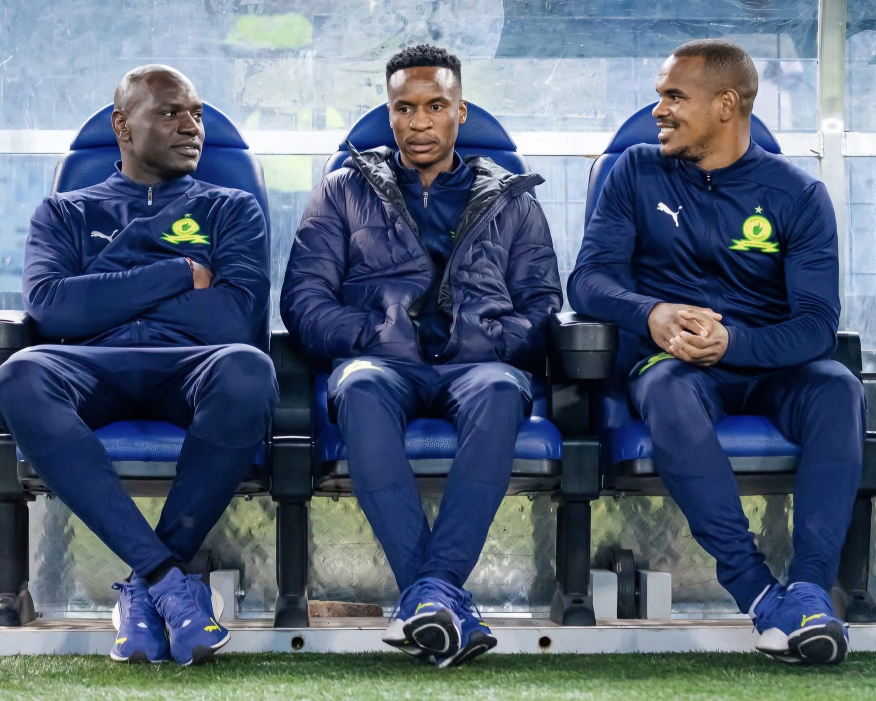 Denis Onyango, Themba Zwane and Iqraam Rayners sitting on the bench.