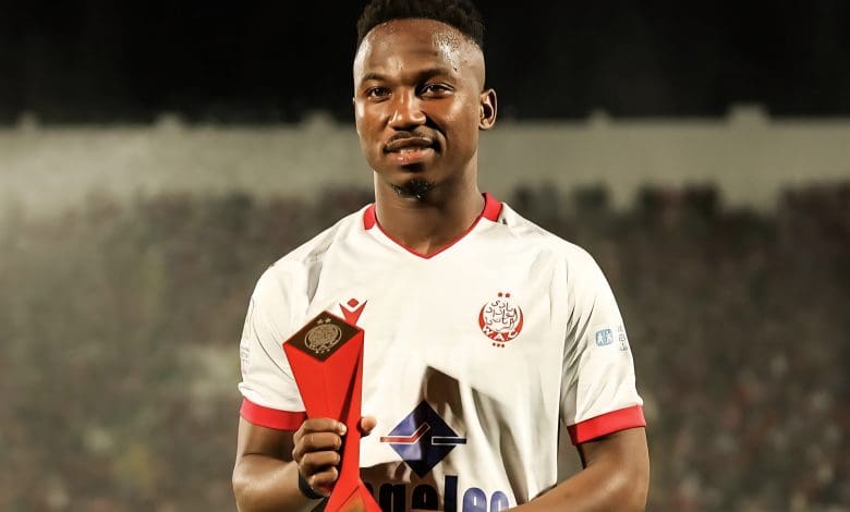 Cassius Mailula holding a man of the match trophy at Wydad AC