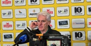 Hugo Broos addressing the media after the draw against Tanzania