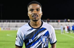 John Mokone holding a man of the match trophy