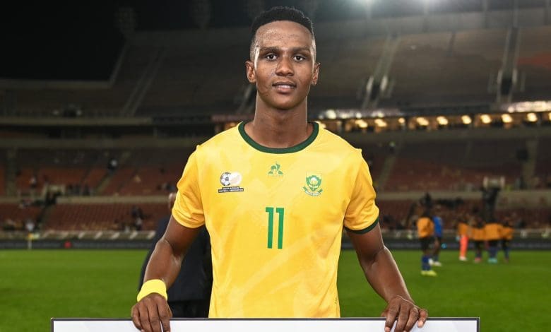 Khulumani Ndamane holding his man of the match award after the international friendly match against Tanzania