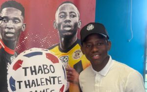 Kaizer Chiefs star Thabo Cele posing with a banner