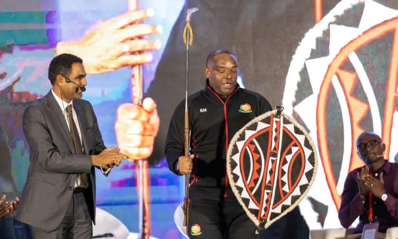 Benni McCarthy holding a spear during his official unveiling as Kenya coach