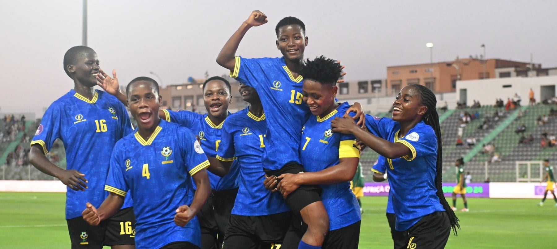 Tanzania national team celebrating after scoring against Banyana Banyana in a WAFCON match