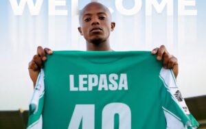 Zakhele Lepasa holding Siwelele FC regalia during his official unveiling