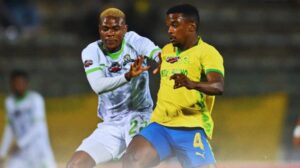 Daniel Msendami and Teboho Mokoena tussle for possession