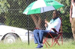 David Thidiela sitting in a chair with a FARPost Umbrella