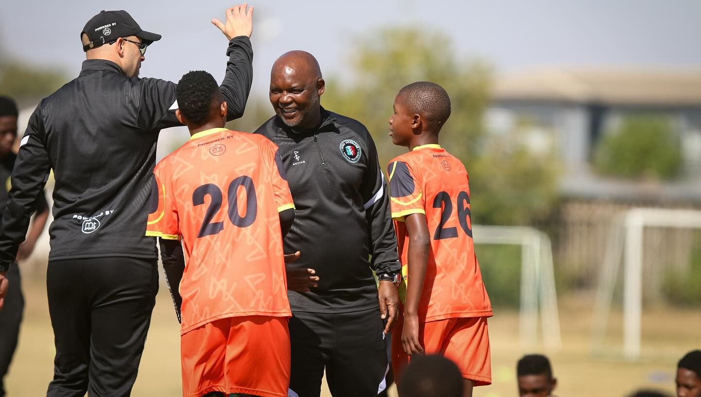 Pitso Mosimane with a coach and players of the Pitso Mosimane Youth Football