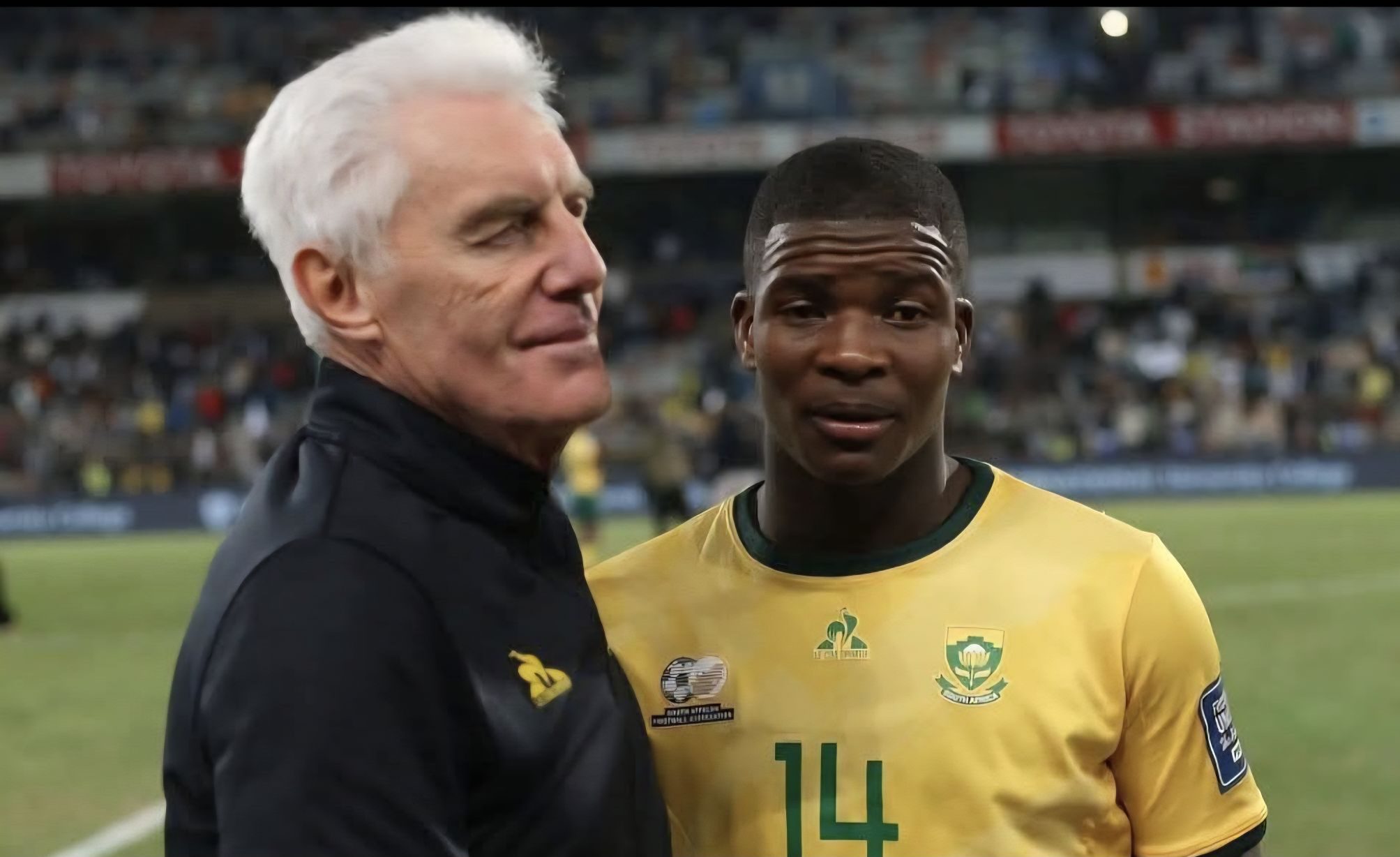 Bafana Bafana coach Hugo Broos having a chart with Mbekezeli Mbokazi after a match 