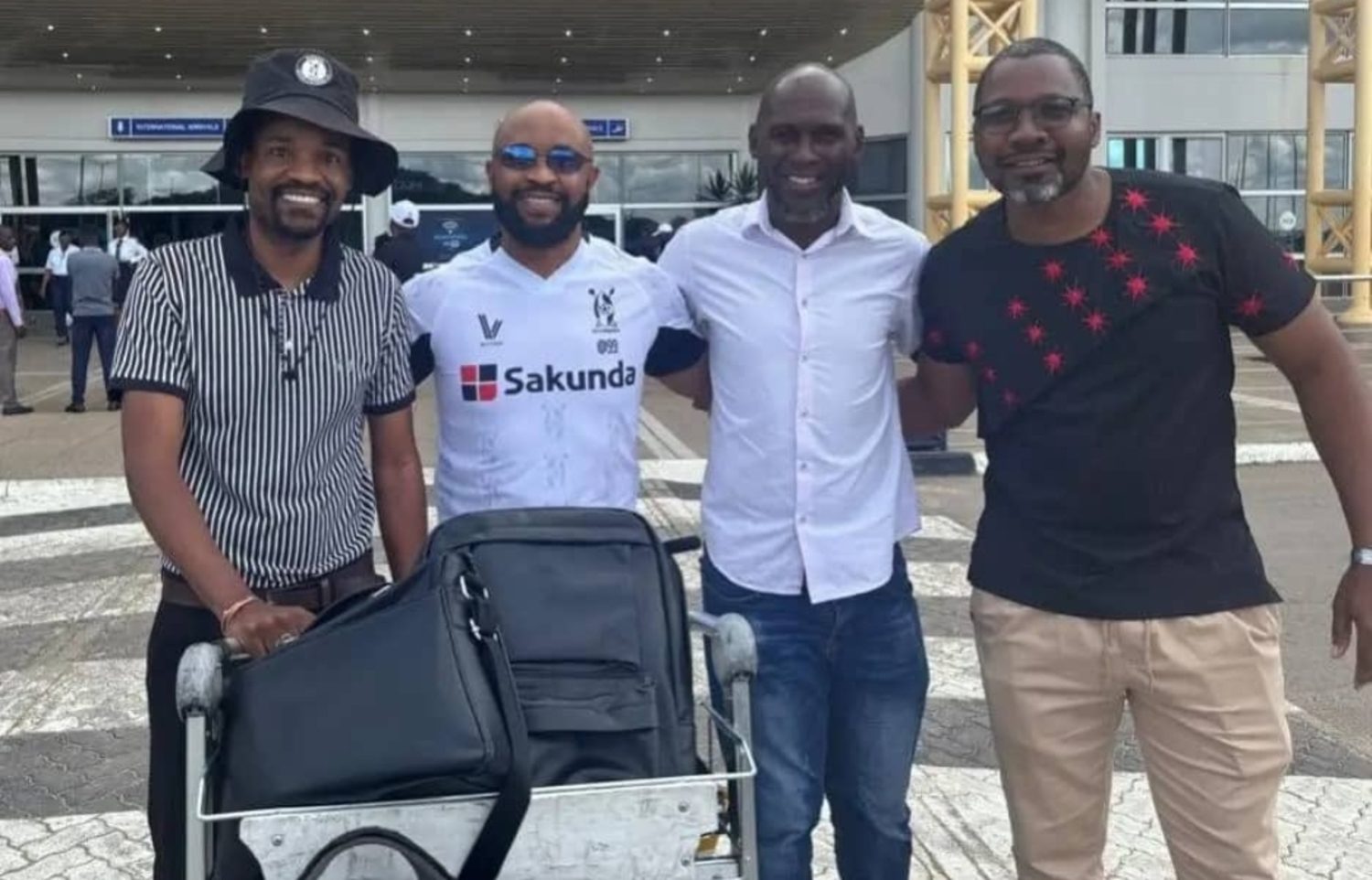 Thabo Senong is welcomed by Highlanders FC officials at the Joshua Mqabuko Nkomo International Airport in Bulawayo