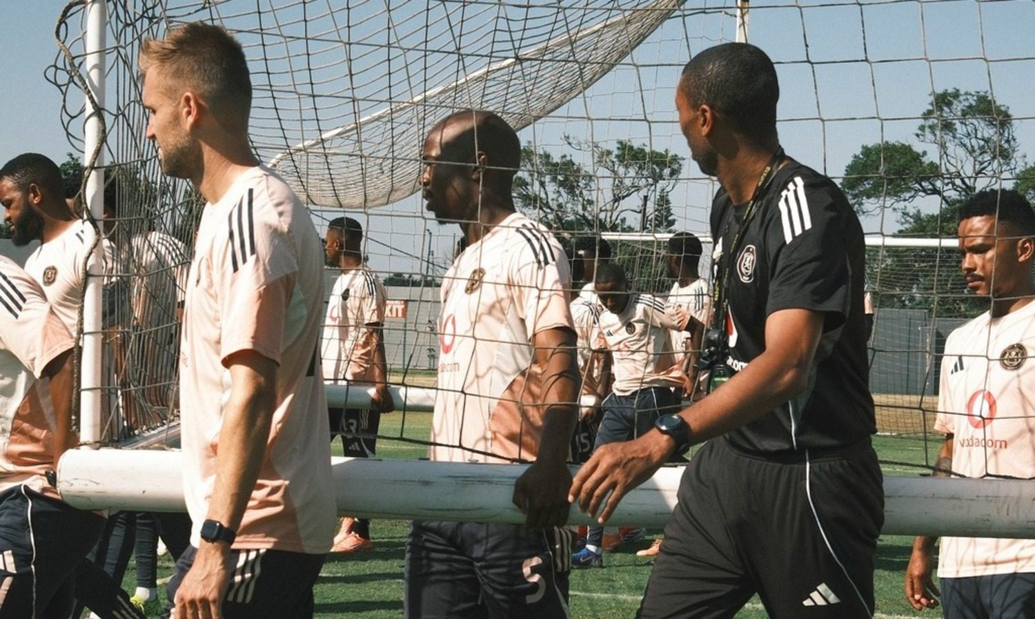 Abdeslam Ouaddou carrying a goalpost with his Orlando Pirates players