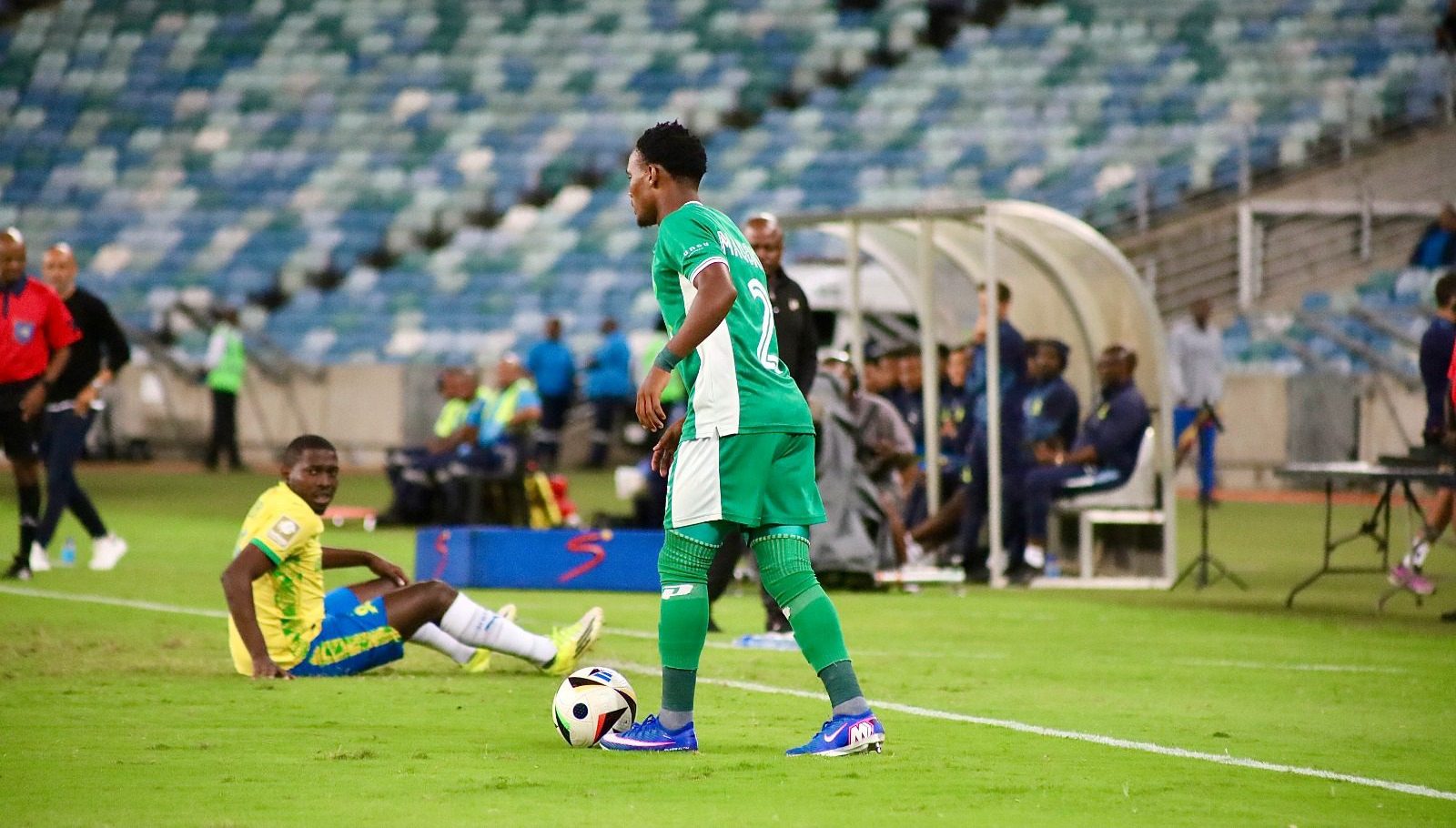 Athini Maqokolo holds the ball as Aubrey Modiba watches on during a League match between AmaZulu FC and Mamelodi Sundowns.