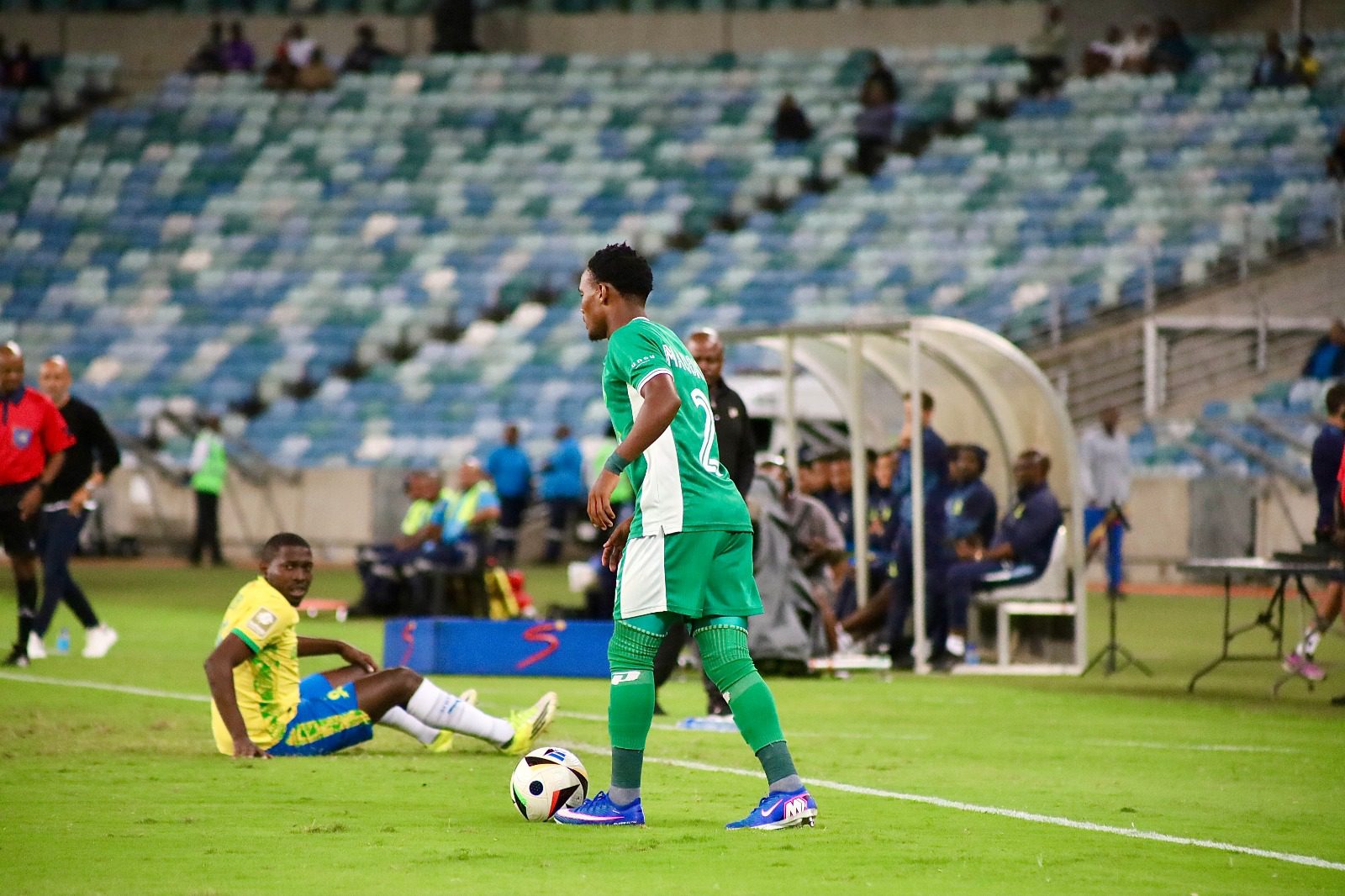 Athini Maqokolo holds the ball as Aubrey Modiba watches on during a League match between AmaZulu FC and Mamelodi Sundowns.