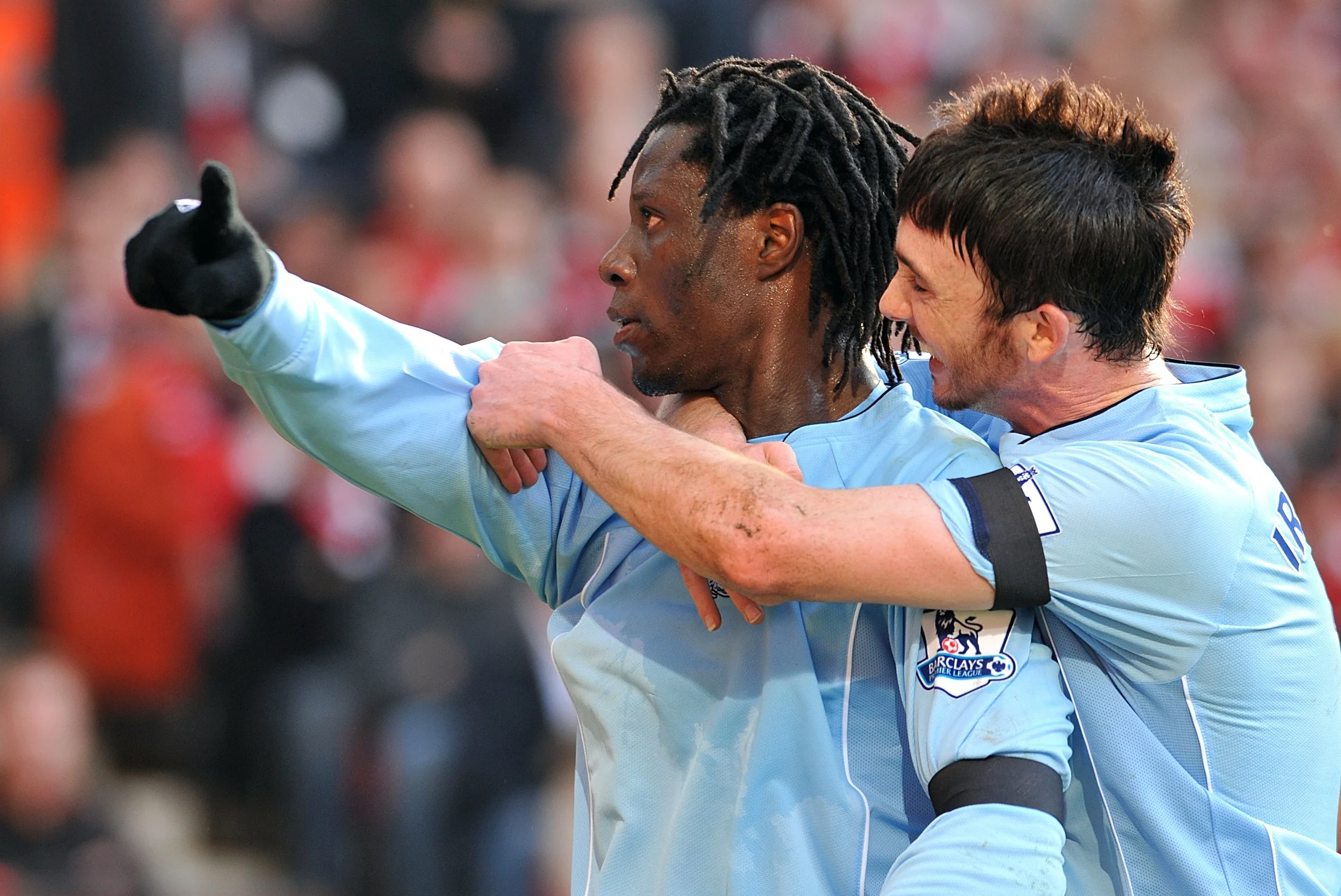 Benjani Mwaruwari celebrates with a teammate at Manchester City