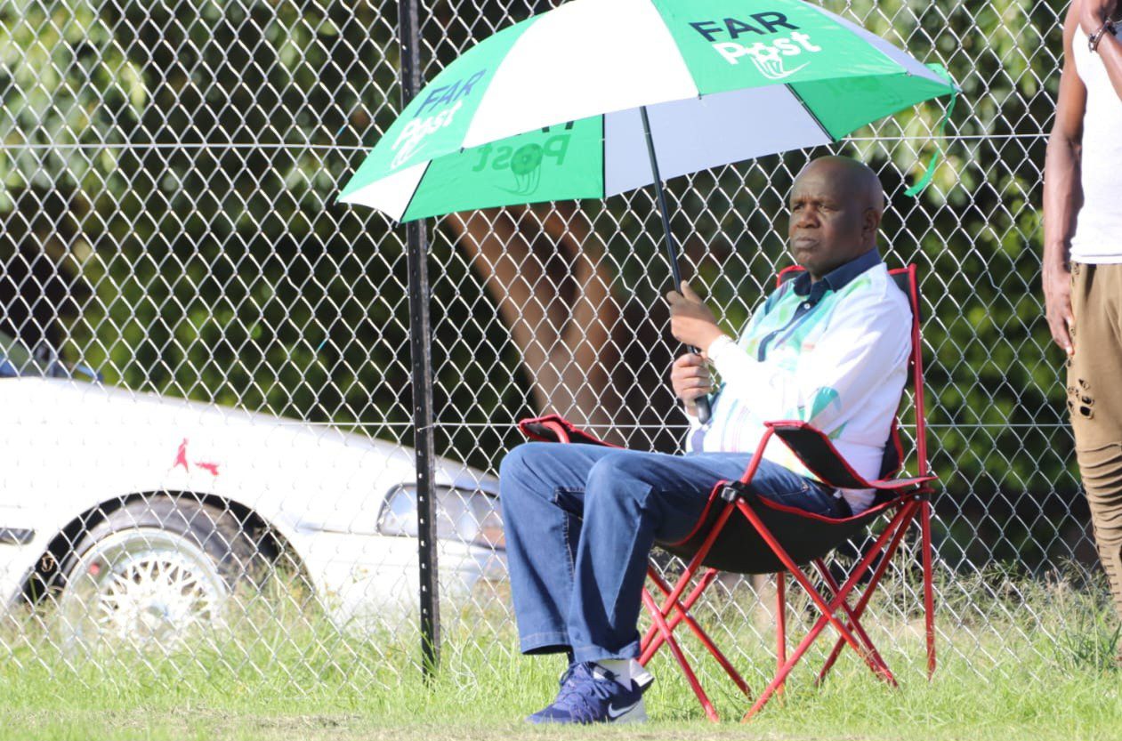 Black Leopards FC Chairman David Thidiela watching a training session in Polokwane with a FARPost Umbrella 