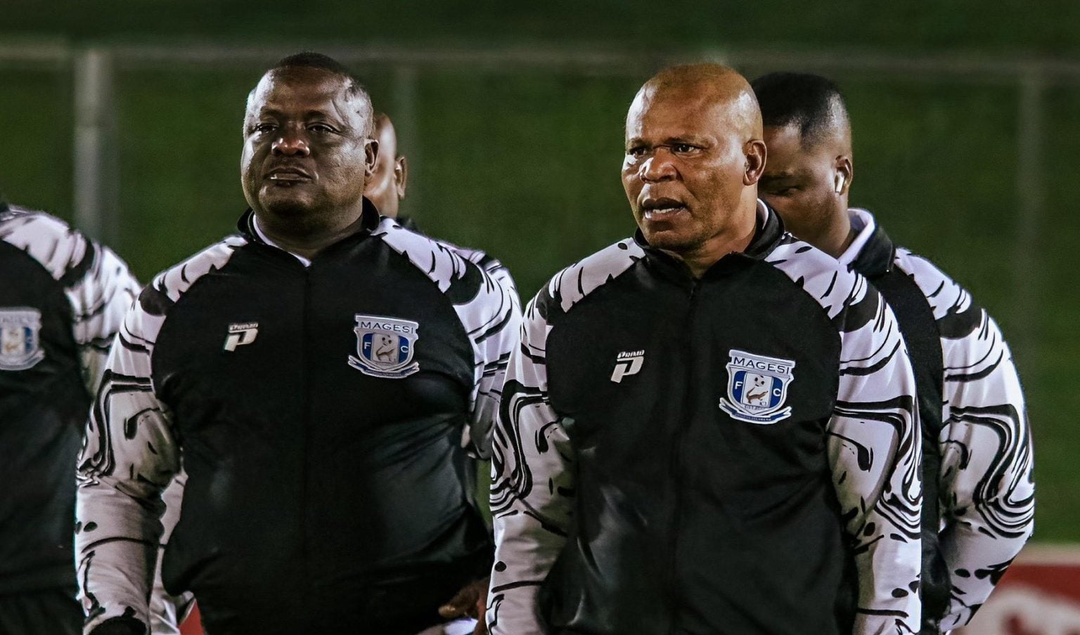 John Maduka and Abram Nteo walking during a pitch inspection