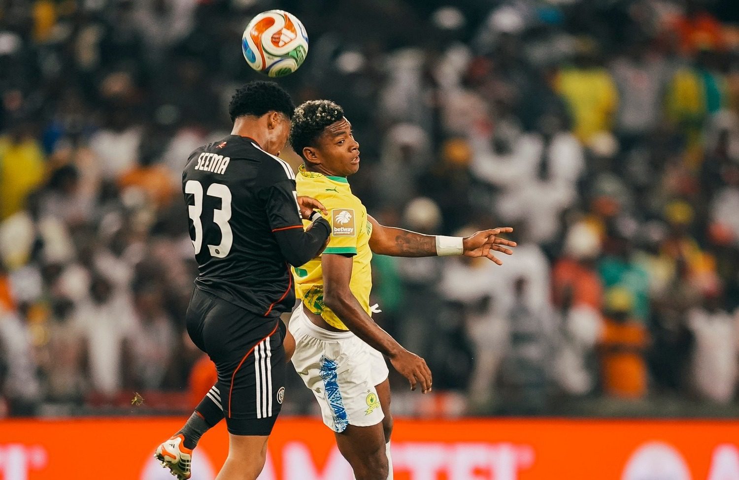 Lebone Seema of Orlando Pirates challenging Mamelodi Sundowns striker Brayan Leon