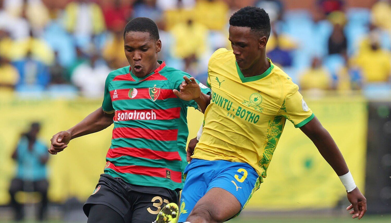 Nkulumani Ndamane of Mamelodi Sundowns challenges an MC Alger's Moslem Anatouf
