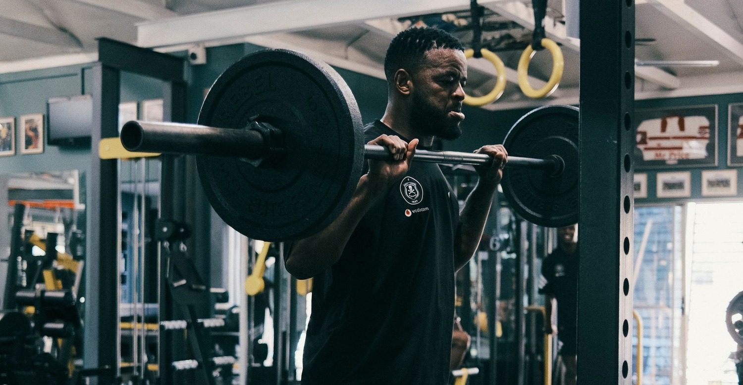 Orlando Pirates midfielder Sipho Mbule lifts weights in the gym