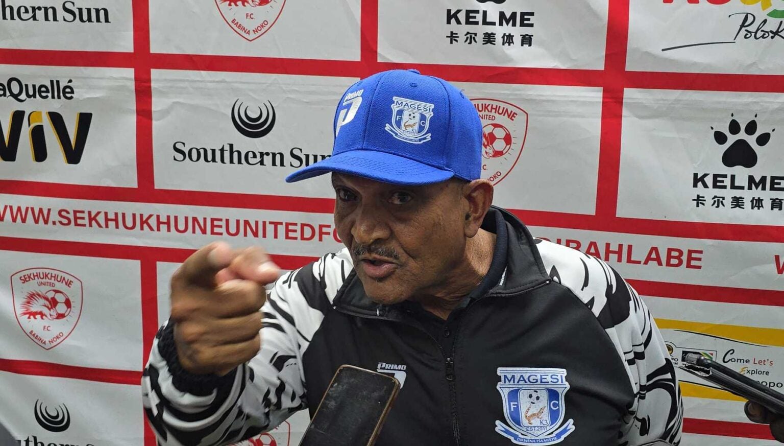 Magesi FC coach Allan Freese pointing a finger during a media briefing