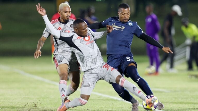 Orlando Pirates right-back Kamogelo Sebelebele challenging Richards Bay defender Thembela Sikhakhane while Oswin Appollis looks on