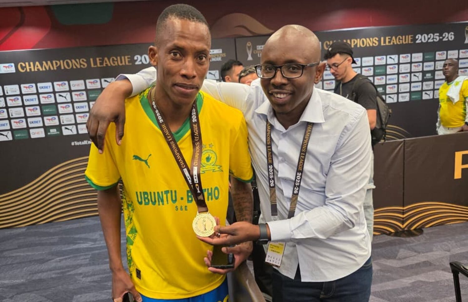 Journalist Mthokozisi Dube shares a moment with Mamelodi Sundowns defender Divine Lunga celebrating the club's CAF Champions League triumph in Rabat, Morocco.