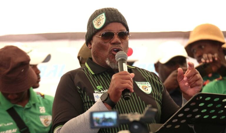 Baroka FC chairman Khurishi Mphahlele addressing a gathering alongside his players.
