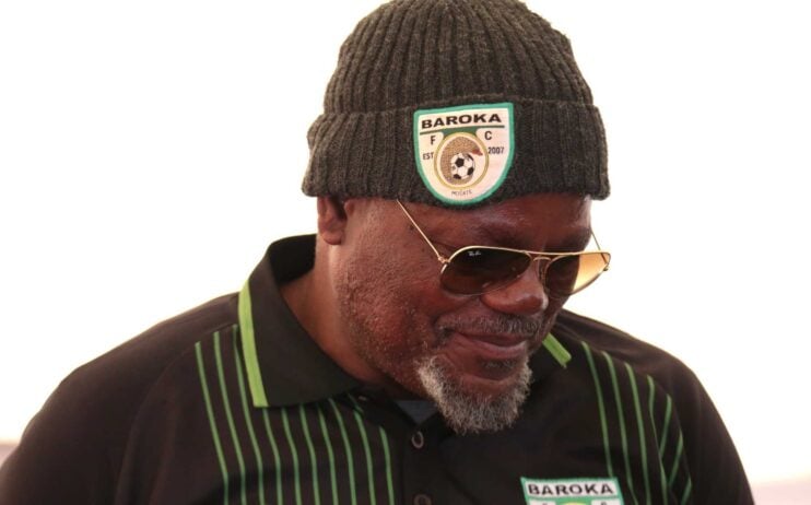 Baroka FC boss Khurishi Mphahlele looking down while wearing a hat.
