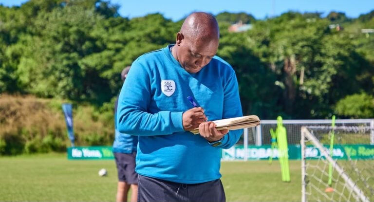 Pitso Dladla writing notes during a training session