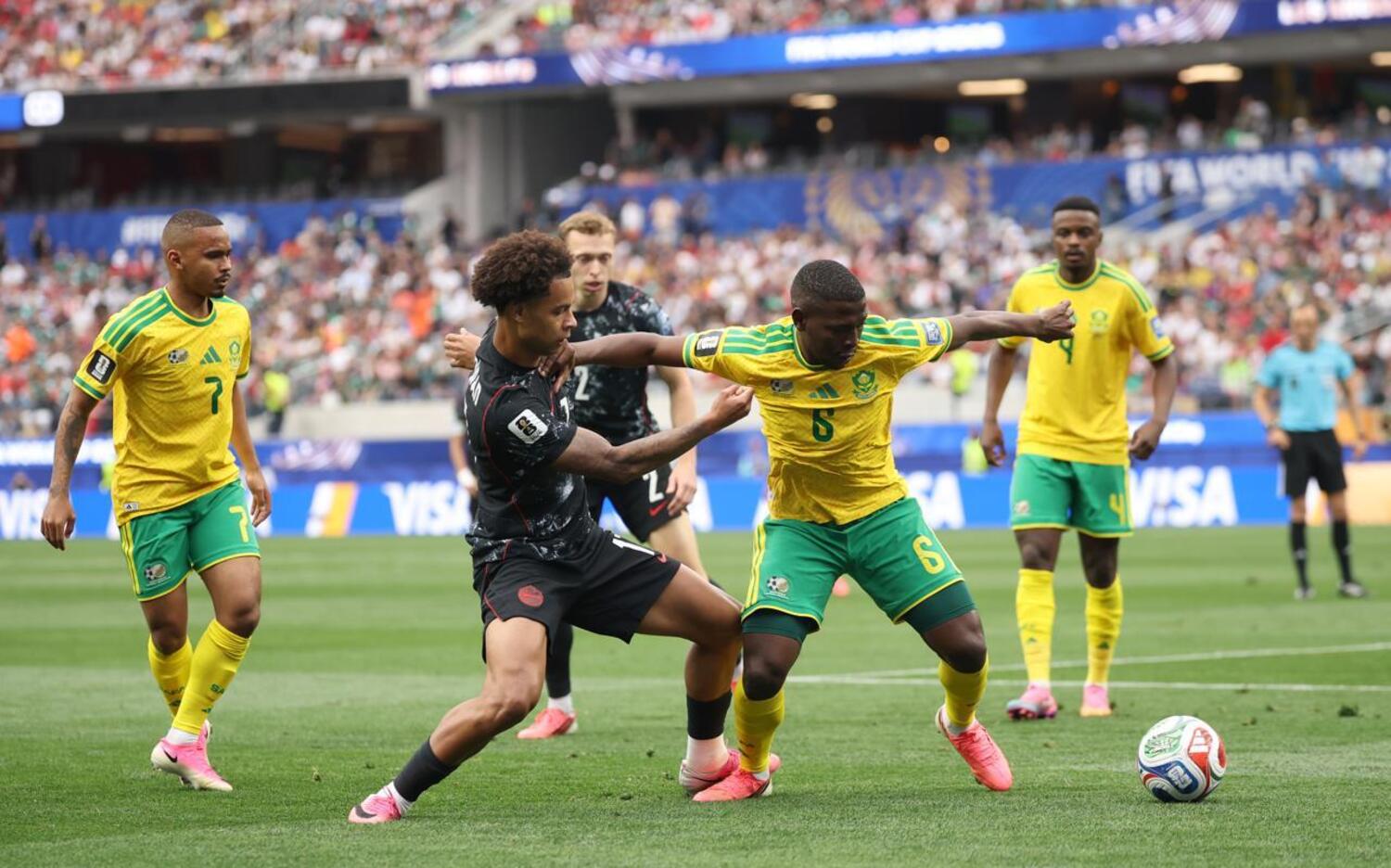 Bafana Bafana left-back Aubrey Modiba trying to beat a Canada player as Oswin Appollis and Teboho Mokoena look on