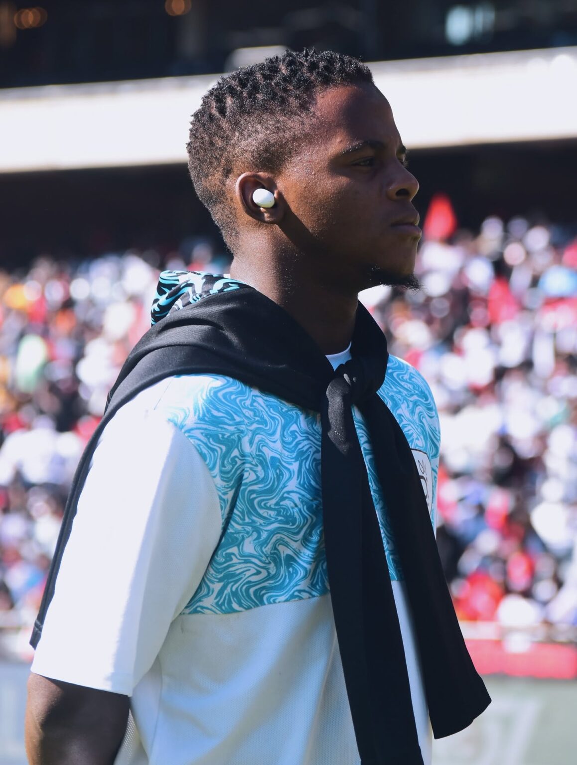 Durban City FC midfielder Luphumlo ‘Kaka’ Sifumba doing a pitch inspection while listening to music