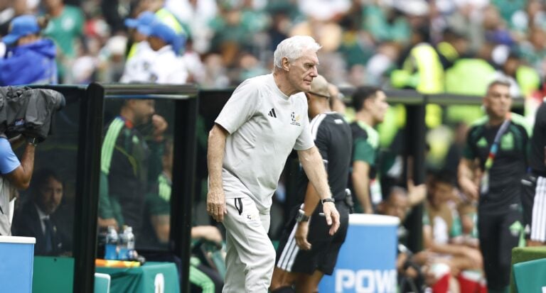 Hugo Broos walking towards the pitch during a World Cup match against Mexico.