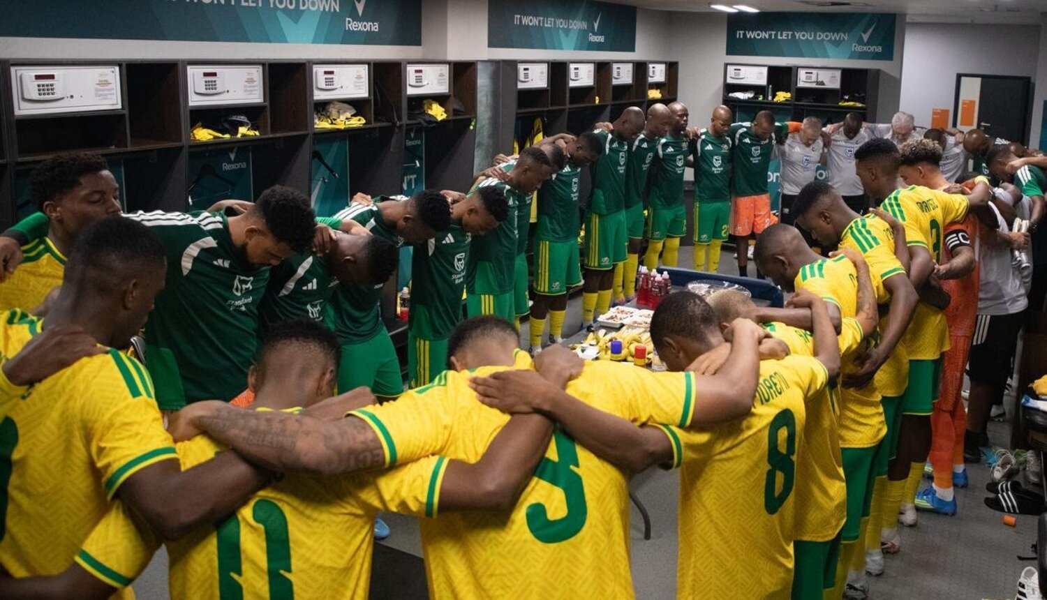 Hugo Broos and his Bafana Bafana players gathering inside the dressing room