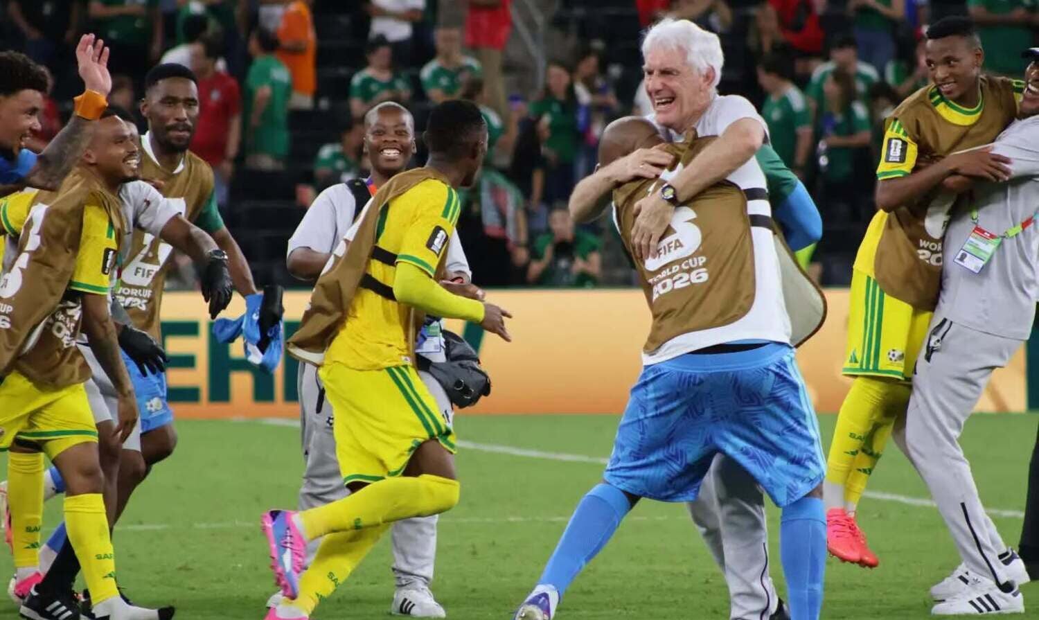 Hugo Broos celebrating with his players after Bafana Bafana beat South Korea at the 2026 FIFA World Cup