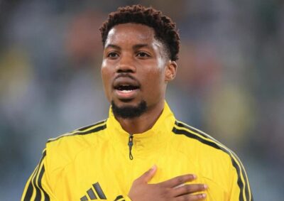Ime Okon singing national anthem in Bafana Bafana colours