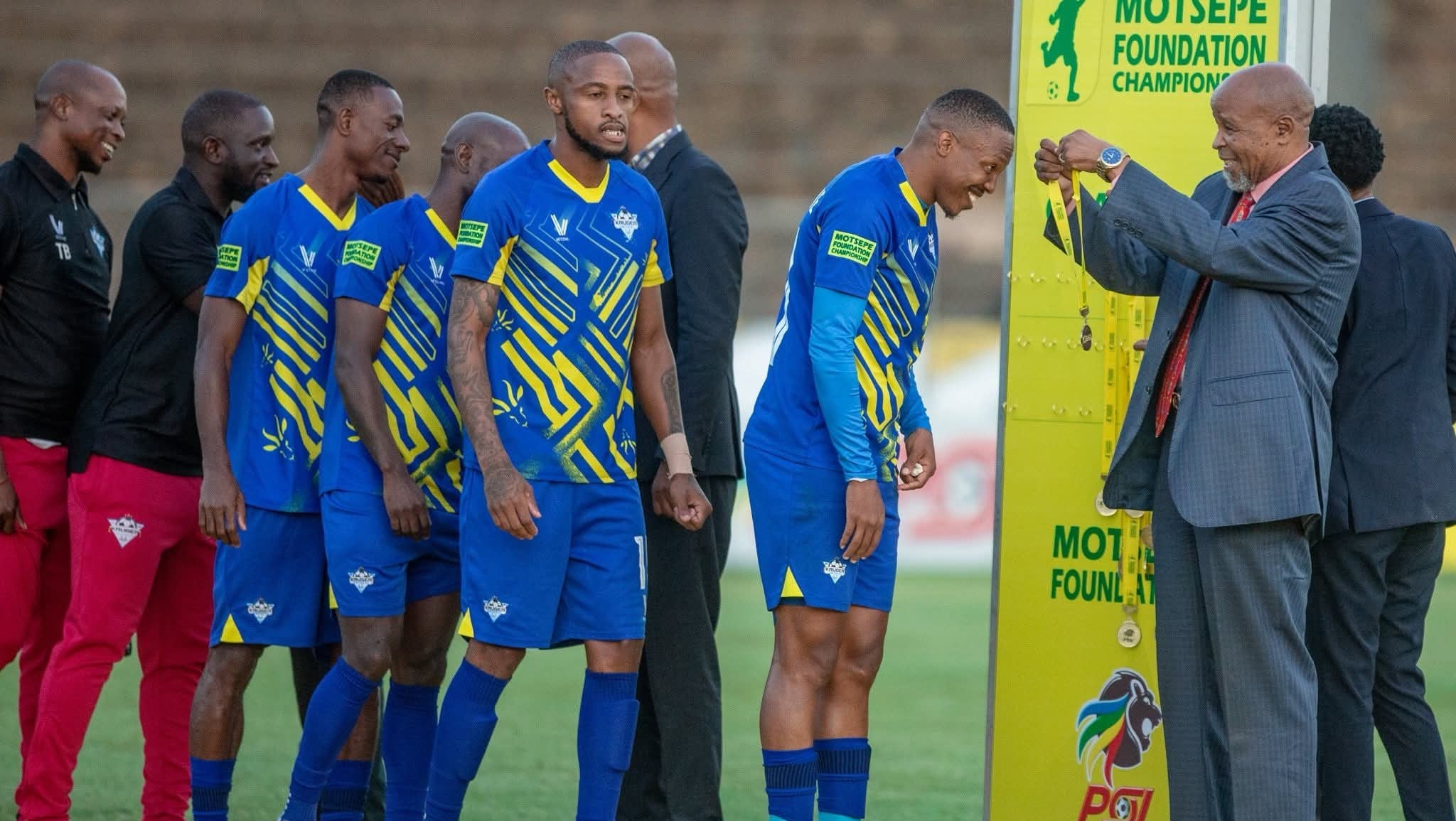 Kruger United players receiving gold medals after winning the Motsepe Foundation Championship